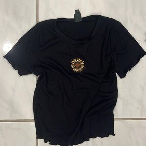 black shirt with a small sunflower